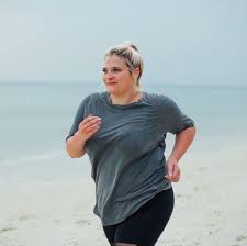 running with large chest on beach