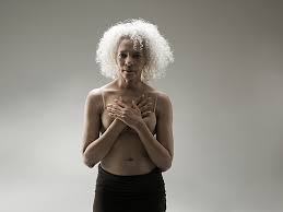 Elderly woman shirtless arms across her chest